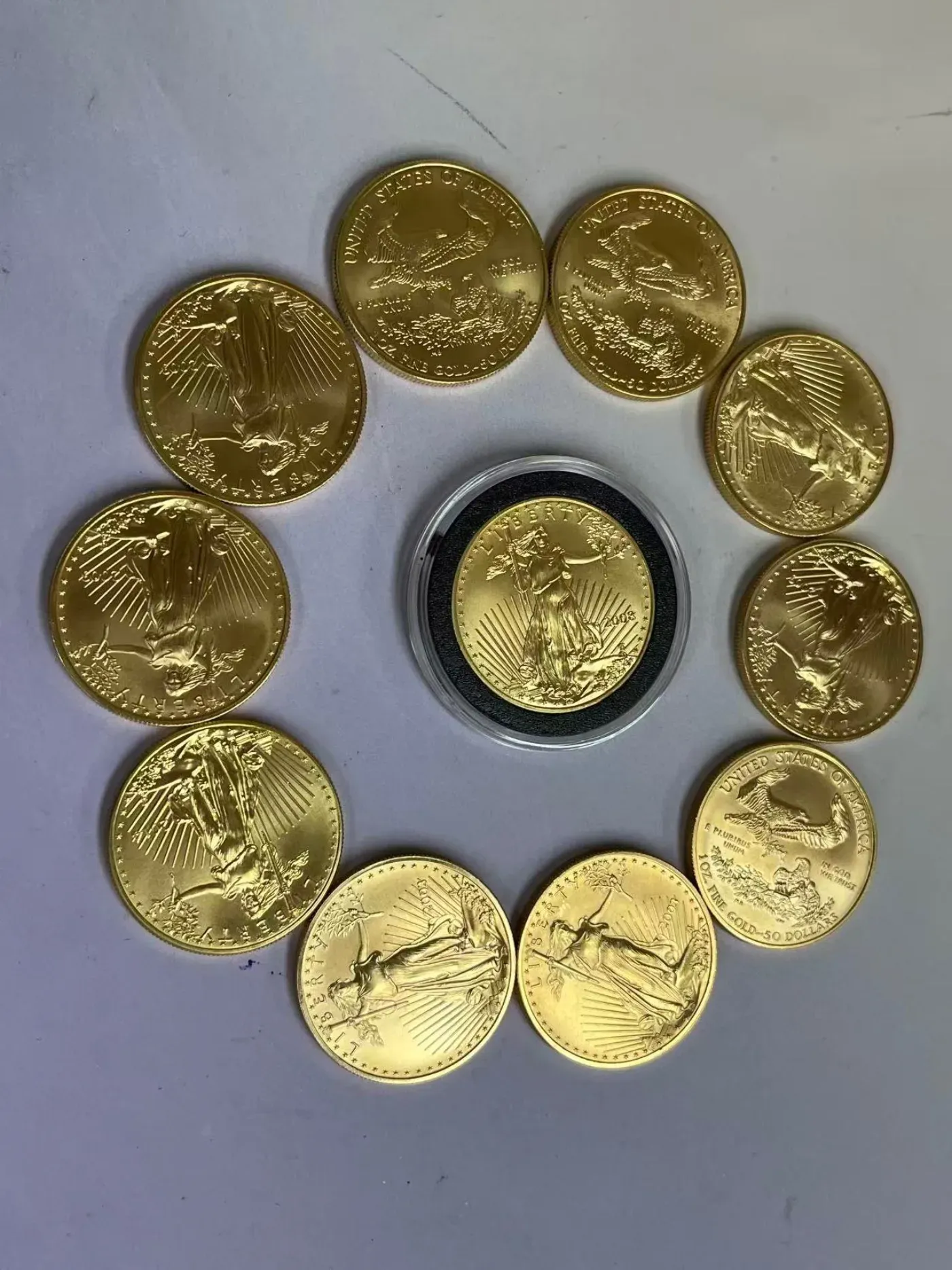 American Gold Eagle 1 oz coins arranged in a circle around an encapsulated proof coin