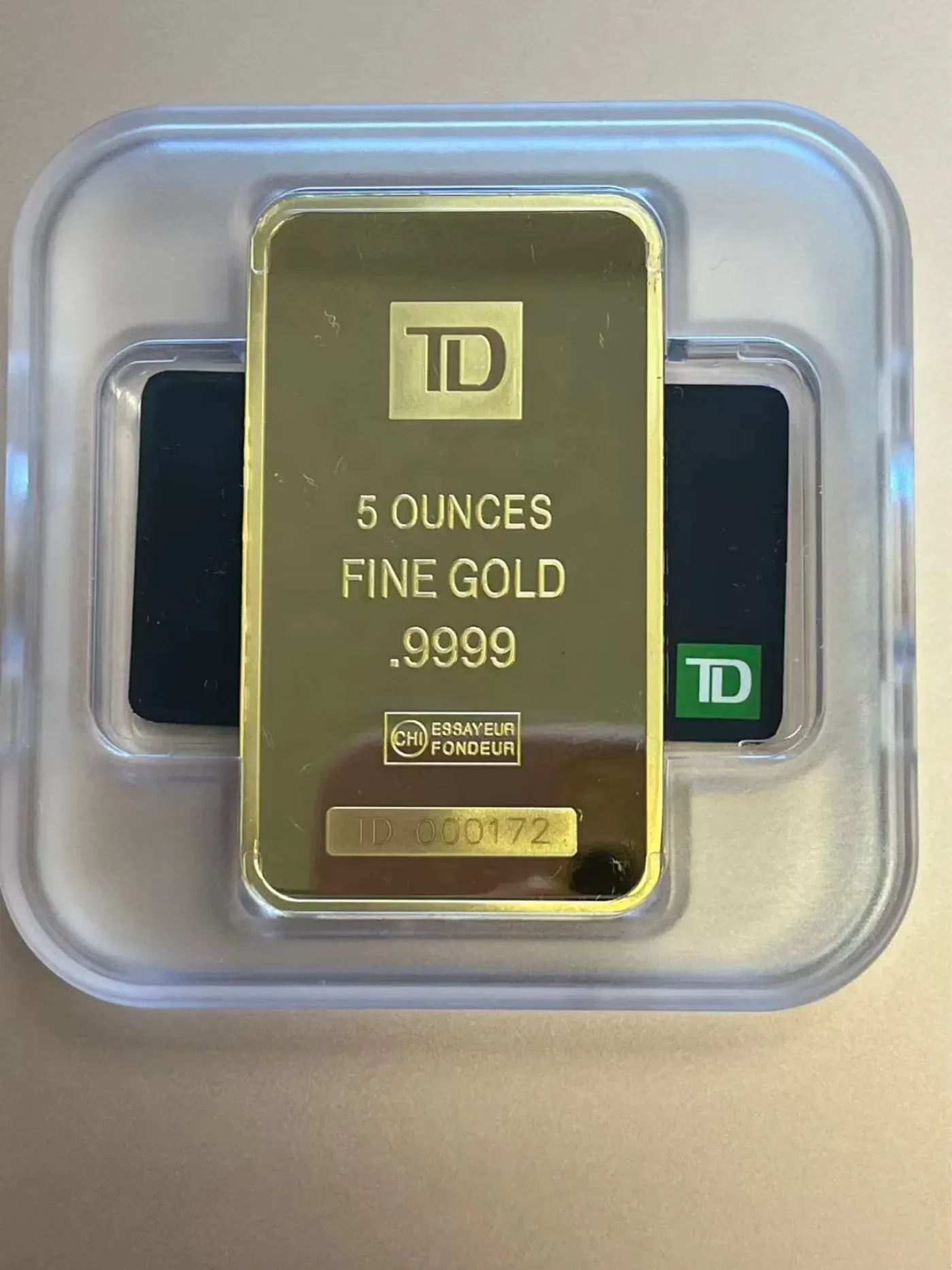 TD 5 ounce .9999 fine gold bullion bar with serial number and assayer mark
